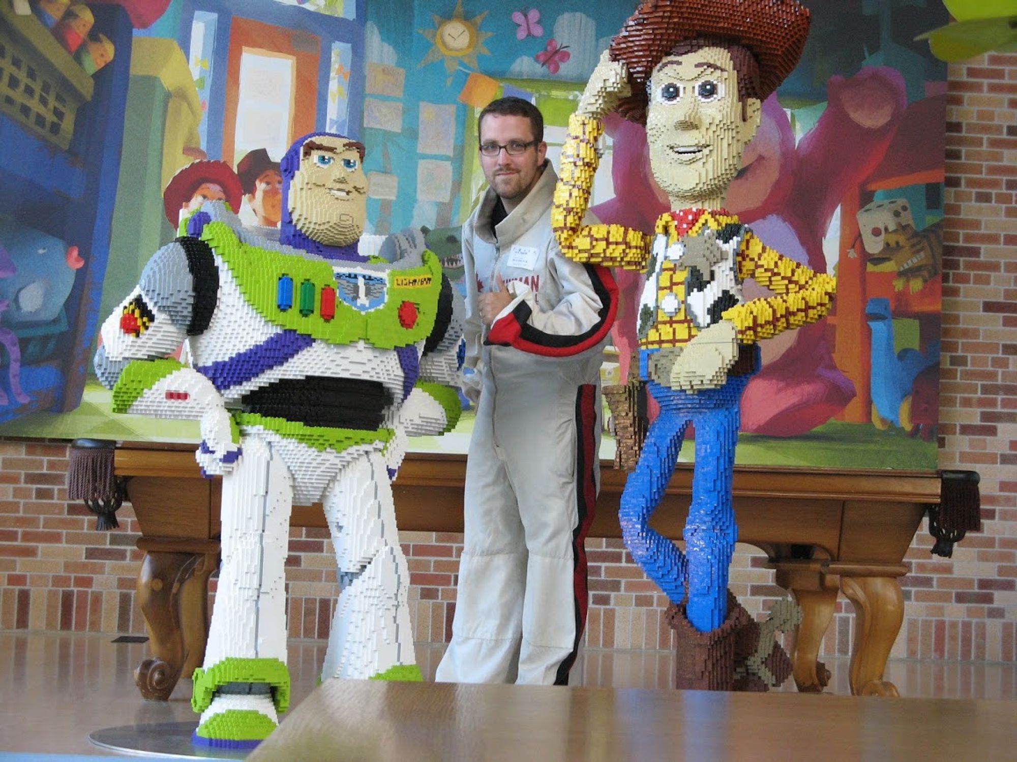 Nick the Human Cannonball poses at Pixar with Lego Buzz & Woody