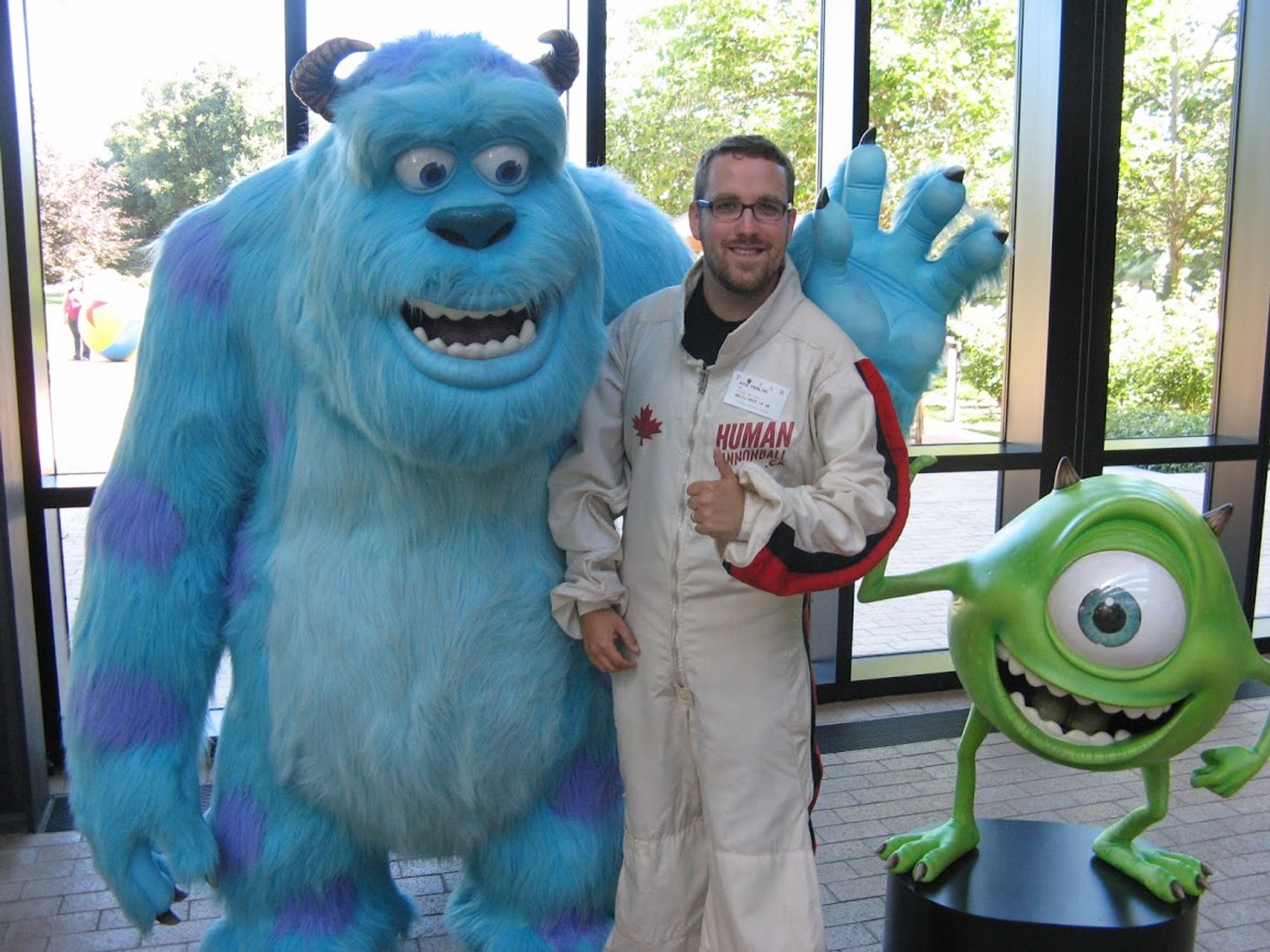 Nick the Human Cannonball poses at Pixar with Mike & Sully
